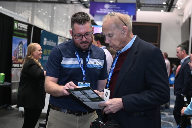 Attendee with another exhibitor at ISS World Expo 2024